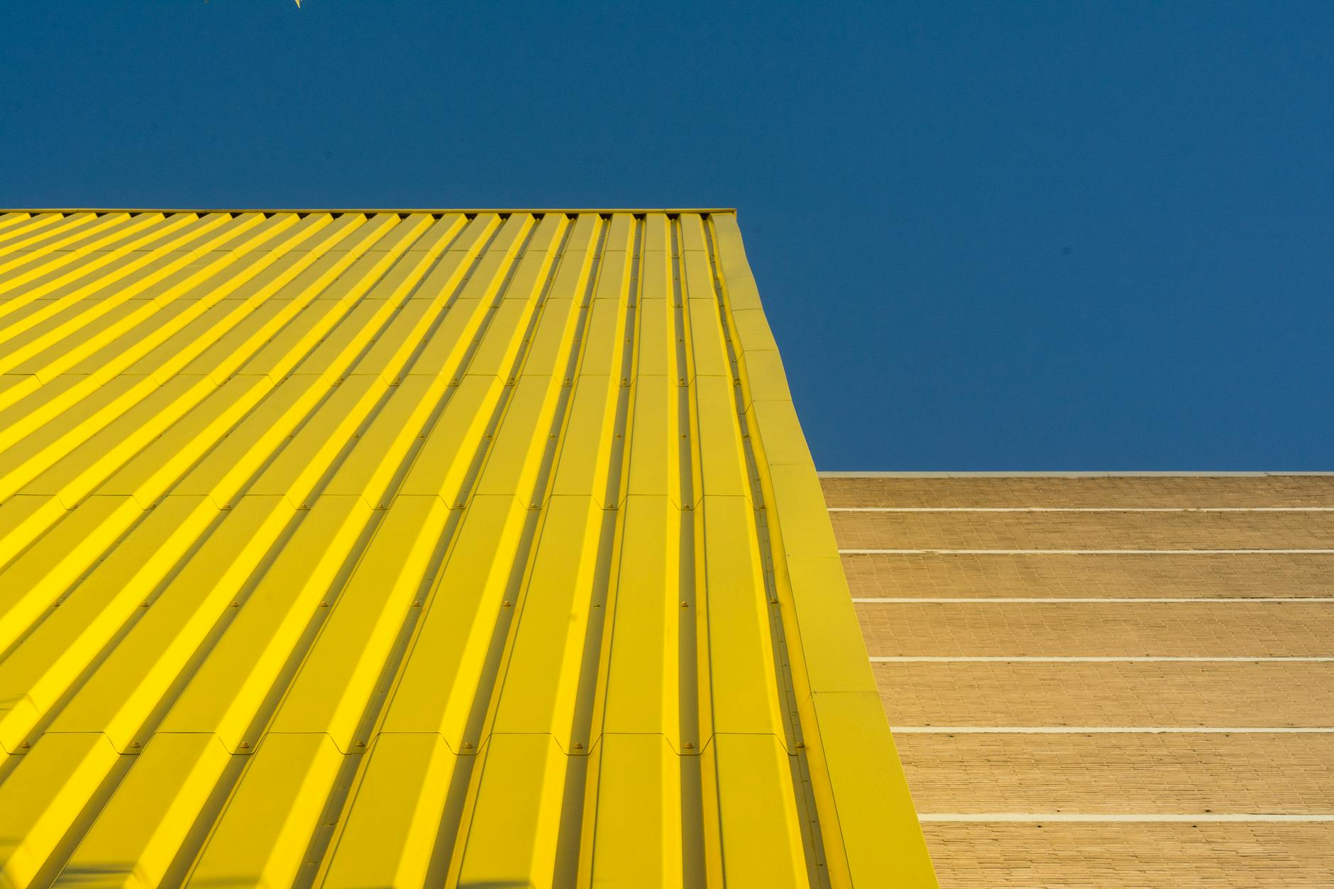 Facharbeiter bei der Renovierung einer Schweizer Hausfassade mit Gerüst und modernen Baumaterialien vor alpiner Landschaft